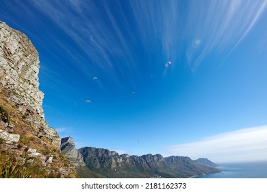 Paragliding Across The Sky, Flying High Above The Ocean And Mountain. For An Adrenaline Filled Summer Of Fun Try An Extreme Sport With A View Of Nature. Adventure Is For The Daring And Brave.