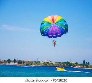 Paragliding In The Clear Sky Above The Sea