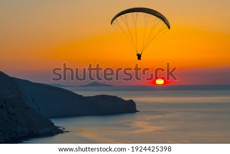 Paragliding concept, paraglider pilot fly in sky on beauty nature mountain and sea coast landscape Crimea background, horizontal photo