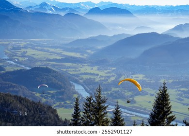 Paragliding. Flight over the Inn Valley and the Kitzbühel Alps (Tyrol, Austria) in early winter. Mountains and valleys in the mist - Powered by Shutterstock