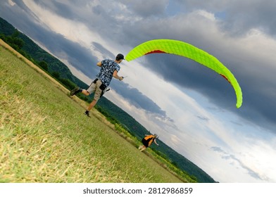 Paragliding Instructor Assisting Pilot Before Takeoff