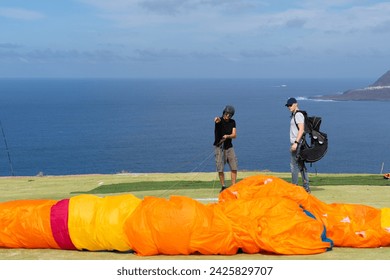 Paragliding instructor teaching a student - Powered by Shutterstock