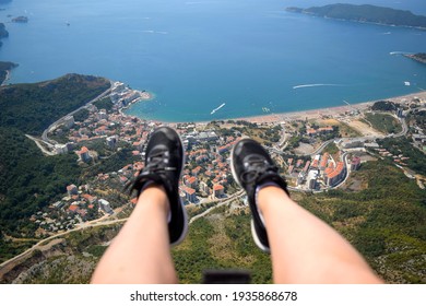 Paragliding In Montenegro City And Ocean View. Girl Legs In The Air Extreme Sport