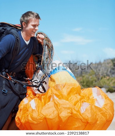 Paragliding, parachute or man in nature with equipment, preparation or helmet to exercise for health. Athlete, extreme and sports with fitness for outdoor wellness, backpack and happy in countryside