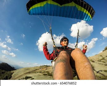 Paragliding pilot smiling in blue sky day, freedom concept.