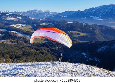 Paragliding: the start. Panoramic view over meadows and hills at the foot of the Zahmer Kaiser (Alps, Tyrol, Austria) - Powered by Shutterstock