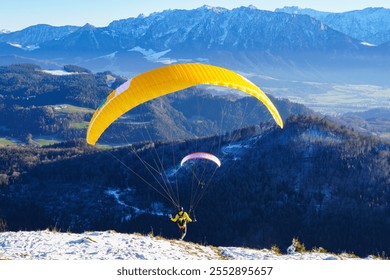 Paragliding: the start. Panoramic view over meadows and hills at the foot of the Zahmer Kaiser (Alps, Tyrol, Austria) - Powered by Shutterstock