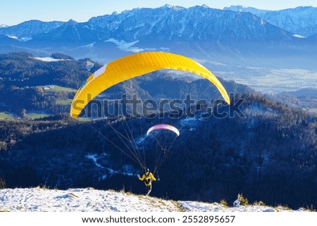 Paragliding: the start. Panoramic view over meadows and hills at the foot of the Zahmer Kaiser (Alps, Tyrol, Austria)