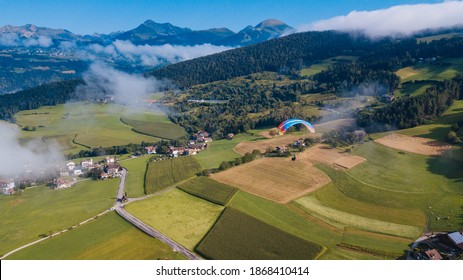 Paragliding Through The Clouds. Beautiful Landscape. Extreme Sport. View From Above.