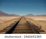 Parallel rail tracks in the Chiguana salt flats, Bolivian highlands, South America. Mirage effect on the horizon.