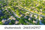 Parallel residential streets with back alleys and row of single-family houses surrounding by lush green trees in suburbs Dallas Fort Worth metro complex, suburban homes swimming pool, aerial. USA