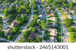 Parallel residential streets with back alleys and row of single-family houses surrounding by lush green trees in suburbs Dallas Fort Worth metro complex, suburban homes swimming pool, aerial. USA