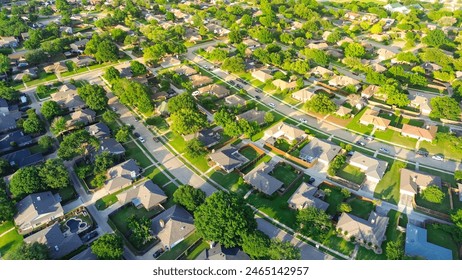 Parallel residential streets with back alleys and row of single-family houses surrounding by lush green trees in suburbs Dallas Fort Worth metro complex, suburban homes swimming pool, aerial. USA - Powered by Shutterstock