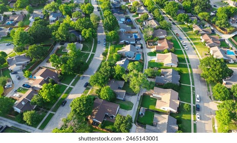 Parallel residential streets with back alleys and row of single-family houses surrounding by lush green trees in suburbs Dallas Fort Worth metro complex, suburban homes swimming pool, aerial. USA - Powered by Shutterstock