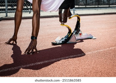 Paralympic sprinter with prosthetic legs started racing from a starting block  - Powered by Shutterstock