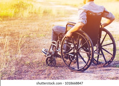 Paralyzed man using Wheelchair outdoor 