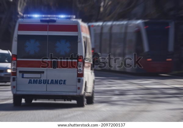Paramedic 911 ambulance car running fast through\
the big city.