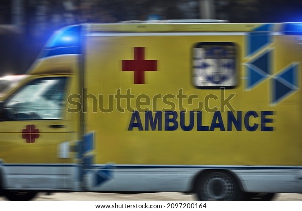 Paramedic 911 ambulance car running fast through
the big city.