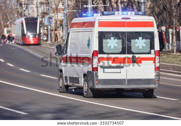 Paramedic 911 ambulance car running fast through\
the big city.