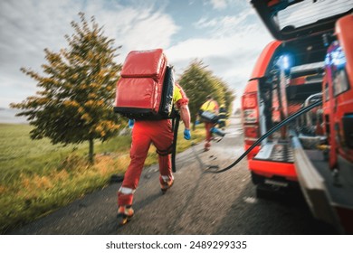 Paramedic and doctor of emergency medical medical service in blurred motion. Team of rescuers running to traffic accident. Themes rescue, urgency and health care.
 - Powered by Shutterstock