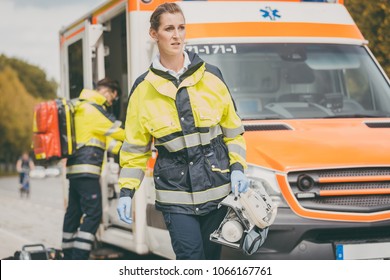 Paramedic Nurse And Emergency Doctor At Ambulance With Kit