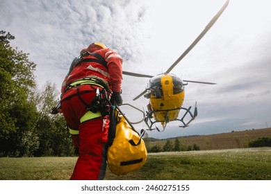 Paramedic with safety harness and climbing equipment running to helicopter of emergency medical service. Themes rescue, help and hope.
 - Powered by Shutterstock