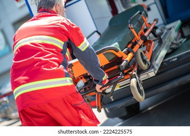 Paramedic Taking A Wheeled Stretcher Out Of The EMS Vehicle