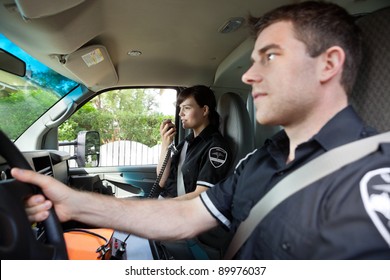 Paramedic Talking On Radio To Dispatcher.  Shallow DOF Critical Focus On Woman With Handset