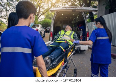 Paramedic Team Transfer Man On Ambulance Stretcher Into Emergency Car.