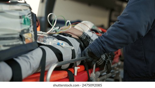 Paramedics, emergency and victim with service, equipment and teamwork with medicare, injury and ambulance. People, medical and professional with patient, first aid and healthcare with skills or trust - Powered by Shutterstock