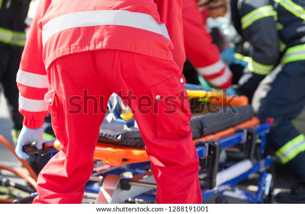 Paramedics and firefighters in urgent rescue\
operation after road traffic\
accident