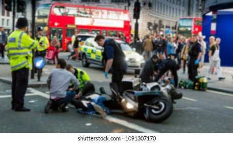 The Paramedics And Firemen Provide First Aid To Victims In A Motorcycle Accident On Piccadilly Street. London. UK. Blurred View