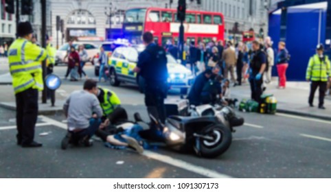 The Paramedics And Firemen Provide First Aid To Victims In A Motorcycle Accident On Piccadilly Street. London. UK. Blurred View