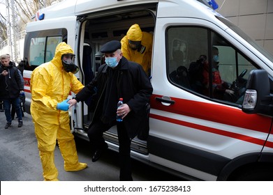 Paramedics Helping An Infected Old Man In Mask To Get From An Ambulance Car To The Department Of Infection Diseases, Coronavirus. February 26, 2020. Kiev, Ukraine