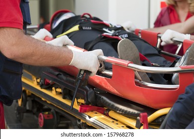 Paramedics Rushing Patient Into An Ambulance