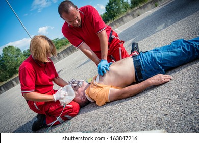 Paramedics succor a man with heart attack - Stock Image - Shutterstock ID 163847216