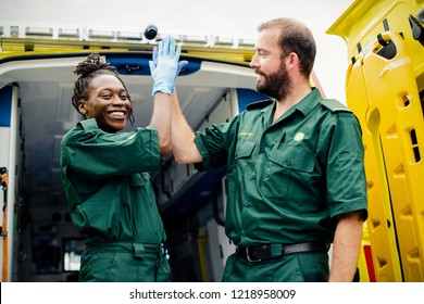 Paramedics team doing a high five - Powered by Shutterstock