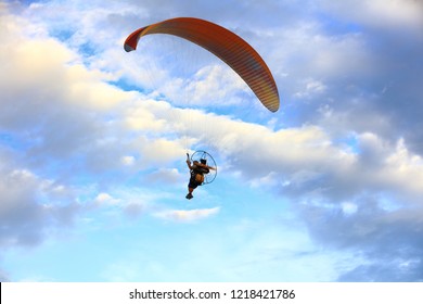 Paramotor flying on the cloud sky