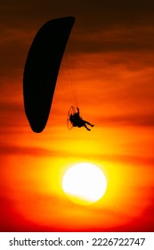 Paramotor flying at the sunset.