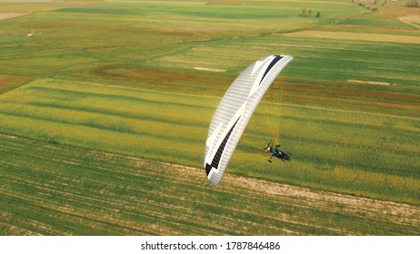 Paramotor Tandem Gliding And Flying In The Air. Copy Space. High Quality Photo