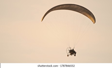 Paramotor Tandem Gliding And Flying In The Air. Copy Space. High Quality Photo