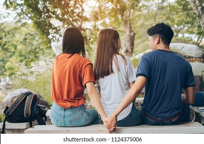 Paramour and divorce secret lovers concept, Asian couple boyfriend holding hands another woman back behind girlfriend threesome unfaithful with friends together.