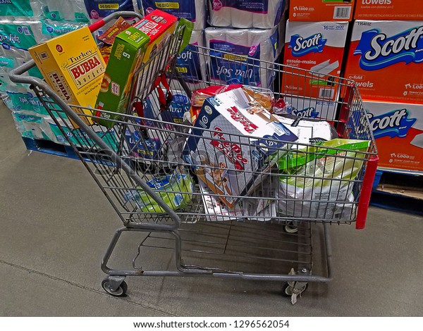 PARAMUS, NEW JERSEY/USA - NOVEMBER 29, 2017:\
A shopping cart filled with various groceries and pet supplies at a\
local BJ\'s Membership Warehouse. This cart was left in the aisle\
unattended.