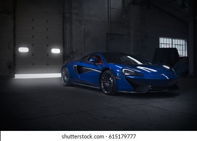 Paramus,NJ - March  25th 2017 - The 2017 McLaren 570GT in pacific blue with a red interior. Front angle view.