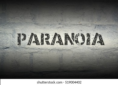 Paranoia Stencil Print On The Grunge White Brick Wall