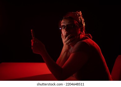 Paranoid Caucasian Woman Using Smartphone Wearing Tinfoil Hat. Conspiracy Theory. 