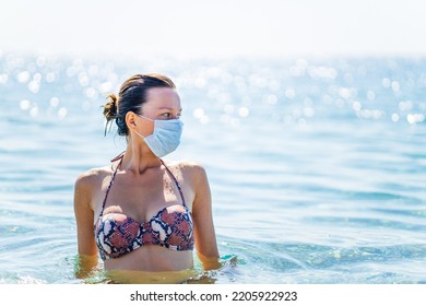 Paranoid Woman Swimming On Water With Mask On Face At Sunny Day