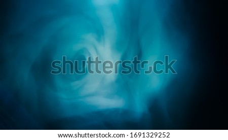 paranormal vortex made by smoke in a bluish light that can be used as a background texture 
