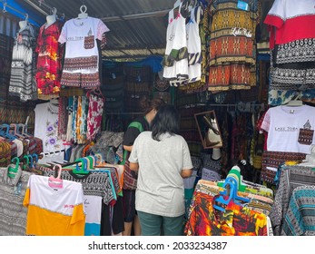 Parapat, North Sumatera: Visitors Bargain Accesories At A Local Clothing Shop In Parapat. Small Medium Enterprises (SMEs) Are Deeply Mpacted By The Pandemic As Less People Visit This Destination. 