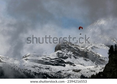 Parasailing above and in front of the Swiss alps